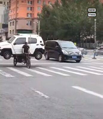 Велосипед вместо эвакуатора: китаец показал необычный способ перевозки машины - autocentre.ua - Китай